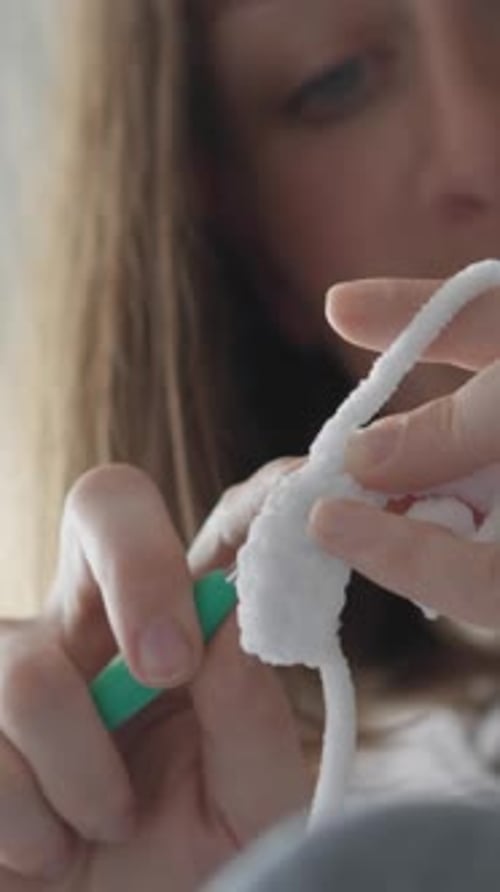 Woman Crocheting Fluffy White Yarn at Home