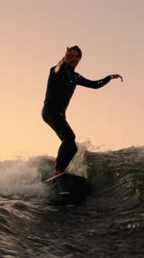 A Passionate Surfer Riding the Waves at Sunset Capturing the Thrill and Joy of Surfing in the Ocean