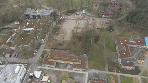 Aerial of construction foundation surrounded by old buildings