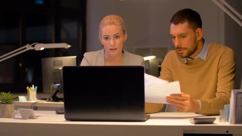 Focused Business Colleagues Working Together Late at Night