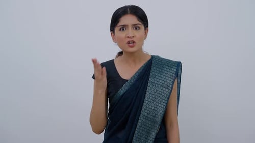 Woman Arguing and Gesturing in Front of White Background