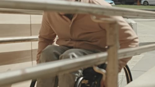 Young Adult Using Wheelchair on Urban Ramp