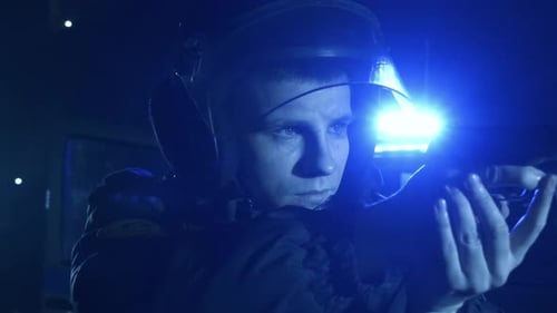 Police Officer with Gun Aiming at Night