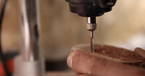 Carpenter Working on the Drill Machine in His Workshop