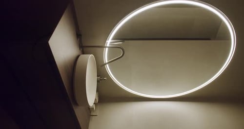 Sleek Minimalist Bathroom with Round Lighted Mirror
