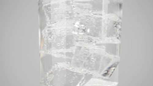 Ice Cubes Floating in Clear Water in Glass