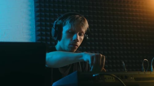 Male Sound Producer Working on a New Track in a Recording Studio