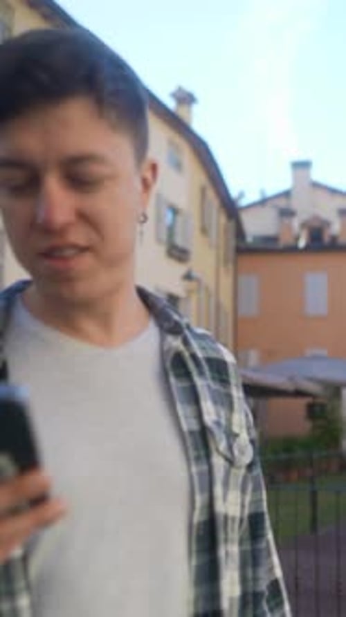 Man Uses Smartphone in Urban Environment
