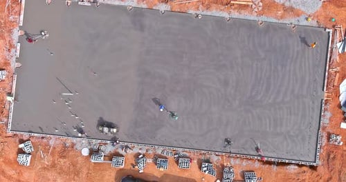 The Process of Polishing and Leveling Cement Screed Mortar Floor on a Construction Site