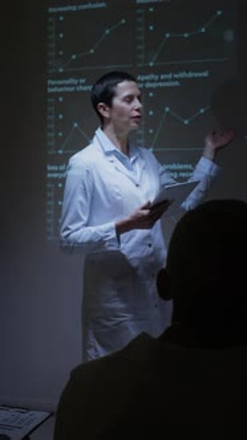 Female Scientist Explaining Brain Visuals during Seminar Presentation