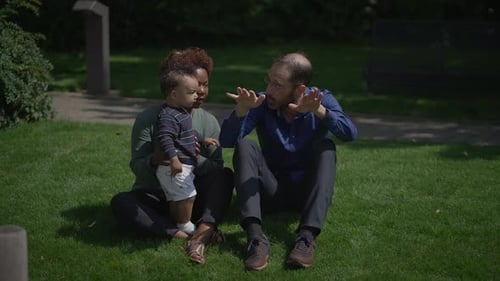 Portrait of a Happy Interracial Family Enjoying Life Together Outside in the Park
