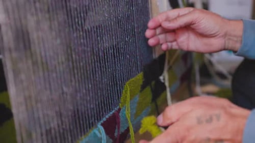 Man Hands Weaving Carpet in Uzbekistan