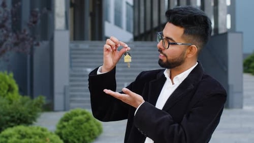 Business Man Real Estate Agent Showing the Keys of New Home House Apartment Buying Renting Property