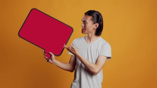 Man Presenting a Red Speech Bubble