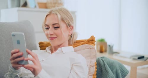 Woman Relaxing at Home Using Smartphone