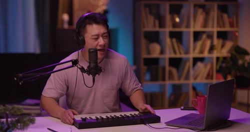 Man sings into microphone at his home studio