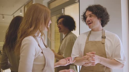 Friendly Colleagues Conversing in Bright Modern Workplace