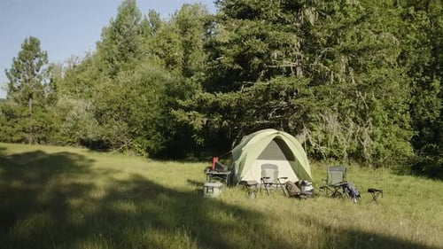 Camping Tent Setup on Green Grass Field