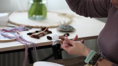 Woman Arranging Colorful Embroidery Thread for Needlework Project