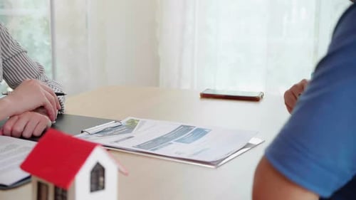 Real estate agent young asian woman talking with elderly couple and explaining mortgage.