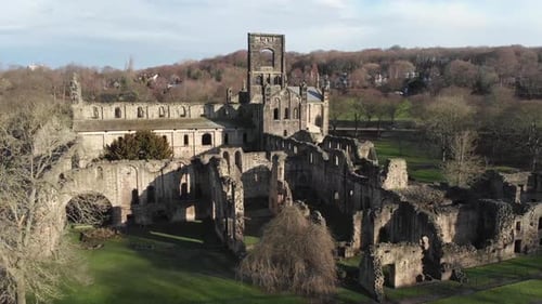 Aerial footage of the ruins of Kirkstall Abbey, a ruined Cistercian monastery in Kirkstall in the UK