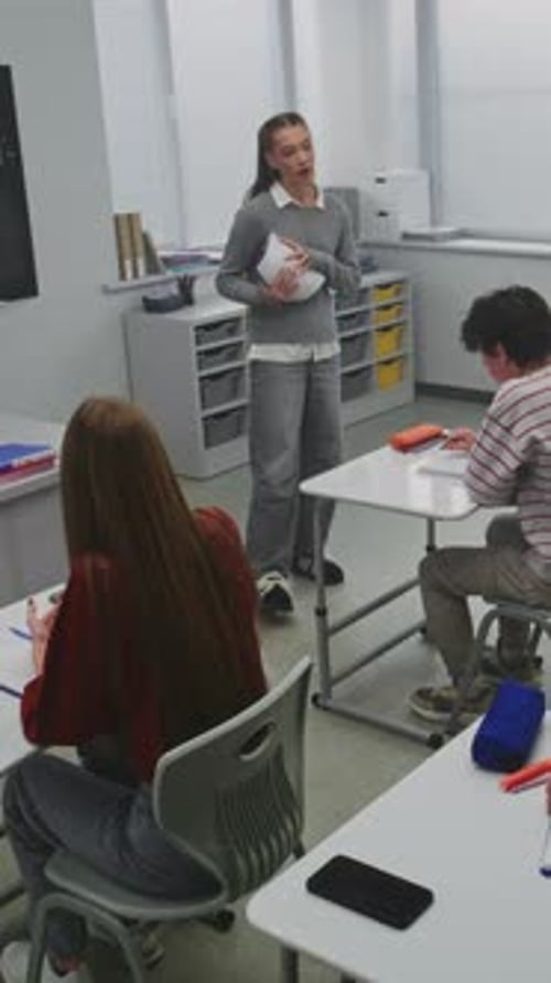 Teacher Explains Lesson to Students in Classroom