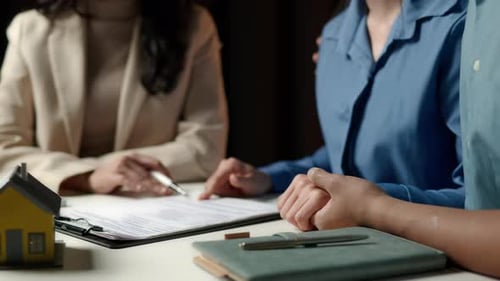 Business seller explain and calculate to wife and husband who buying real estate house properties.