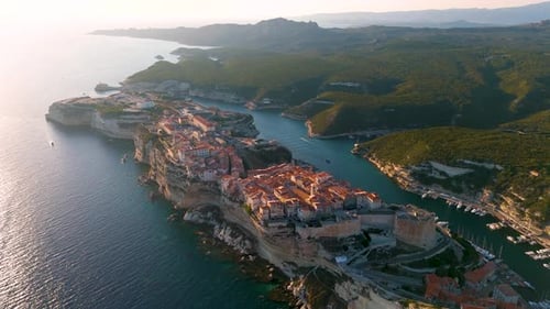 Aerial drone view of Bonifacio, coastal town during sunset, Corsica, France