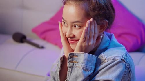 Woman Smiling While Sitting on Couch Indoors