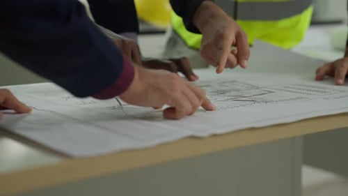 Architectural Team Discussing Plans at Workplace