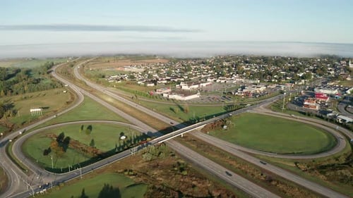 Highway with light traffic and interchange with cars entering and exiting the freeway. Interstate tr