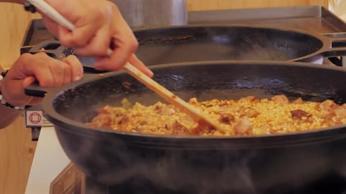 Chef Cooking Traditional Spanish Paella on a Stove Food Festival in Barcelona Spain Chef Cooking