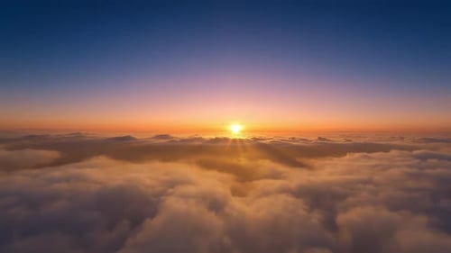 Aerial View of a Peaceful Flight Above Clouds at Sunset