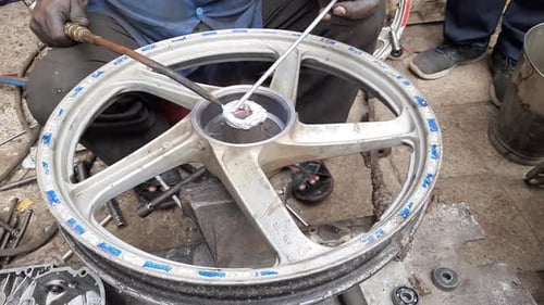 A man wheels in preparation for repair, maintenance, Gas Welding, Repairing Bearing Space