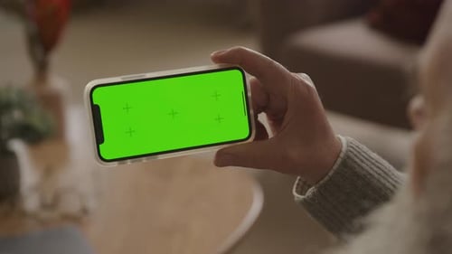 Single Press in Left Side of Green Screen Smartphone Indoors