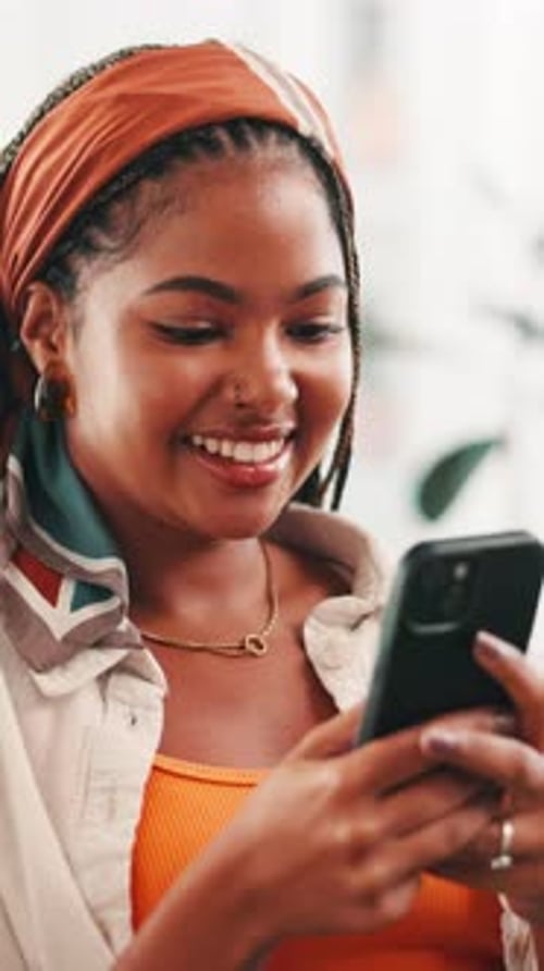 Smiling Woman Using Smartphone Indoors