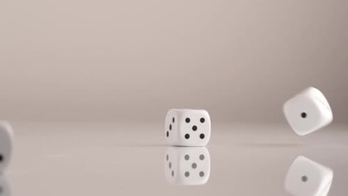 Dice Rolling and Tumbling on a Gray Background