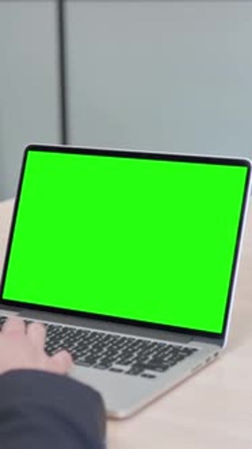 Businessman Using Laptop with Green Screen, vertical video