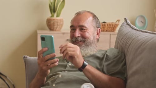 Man Laughing While on Video Call From Home