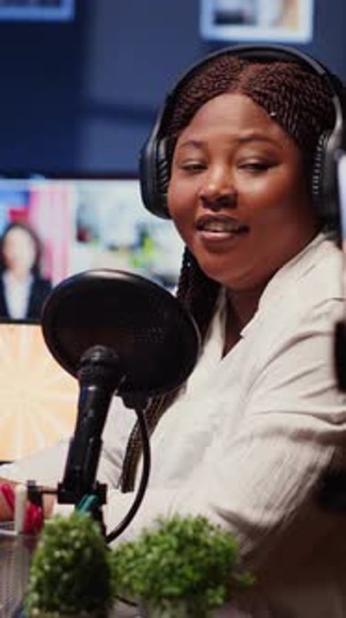 Vertical Video Journalist Records Interview with Cellphone on Tripod Stabilizer in Studio Reviewing