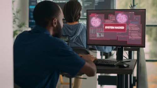 Software Developer Works on Hacked System in Office