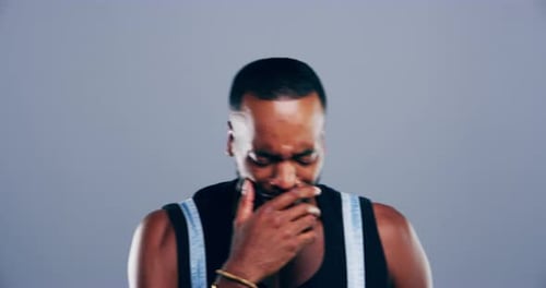 4k video footage of a young man crying against a grey background