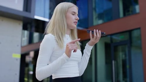 Woman Leaving Voice Message on Mobile Phone