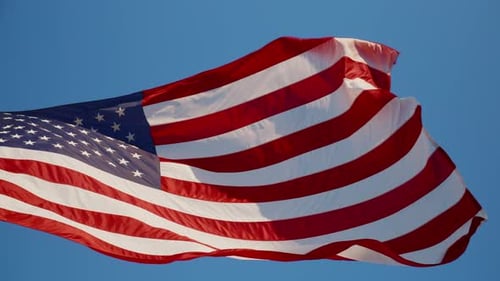 Waving American Flag Against Blue Sky