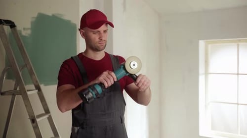 Construction Worker Preparing Angle Grinder for Home Renovation Project