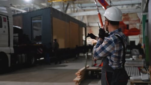 Construction Supervisor Directs Modular Building Transport