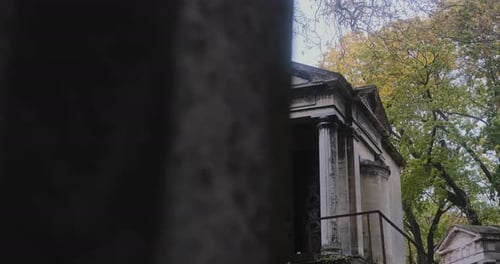 Ornate Mausoleum in Cemetery with Autumn Trees