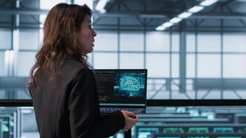 Programmers Coding on Laptop Using Artificial Intelligence in Server Farm