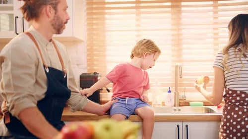 Loving Family Shares an Apple in the Kitchen