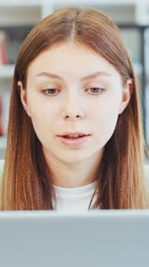 Vertical Screen Focused Student Engages in Video Call Study Session